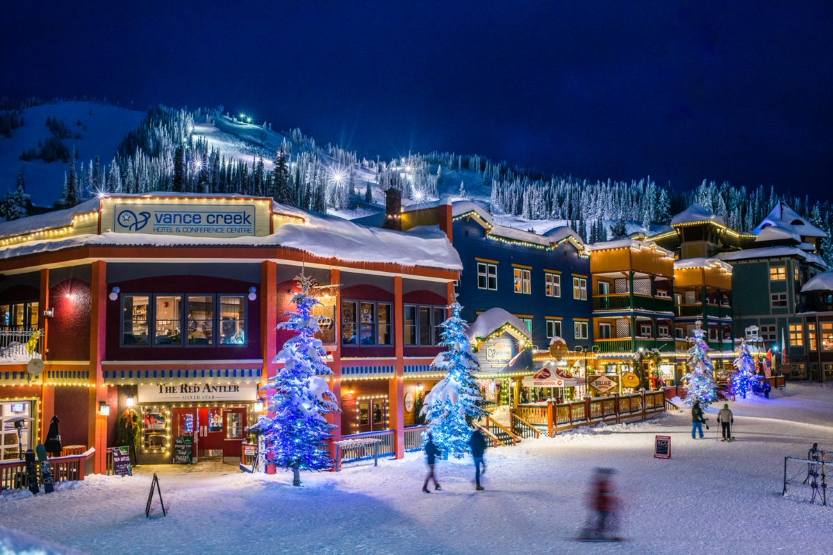 colourful village with lights and snowy mountain resort